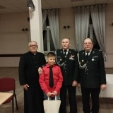  Mieczysław Białuski Prezes OSP  wraz z gośćmi wręcza uczniowi nagrodę za konkurs pożarniczy
